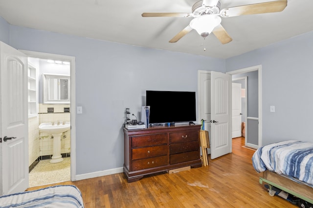1023 Chickasaw Trl, Frankfort, KY 40601 - bedroom with wood finished floors, a sink, a ceiling fan, and connected bathroom