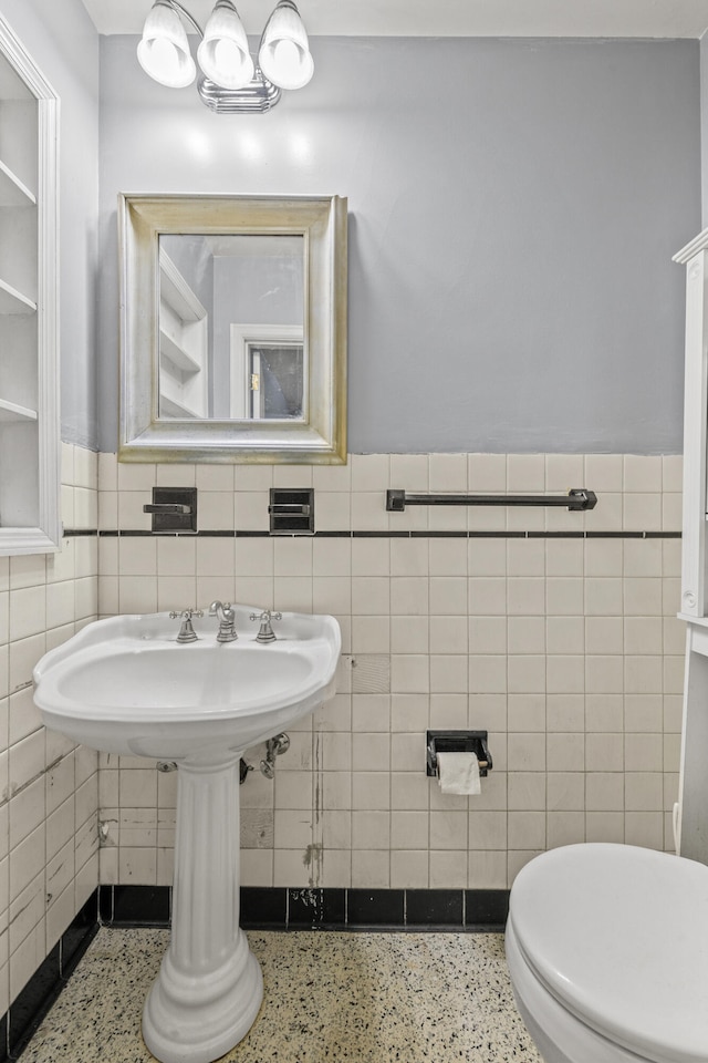 1023 Chickasaw Trl, Frankfort, KY 40601 - half bathroom with tile walls, speckled floor, a wainscoted wall, and toilet