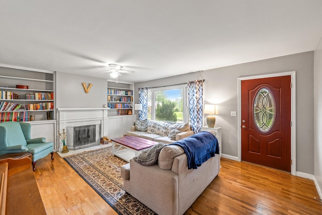 1023 Chickasaw Trl, Frankfort, KY 40601 - living room with a ceiling fan, hardwood / wood-style floors, a fireplace with flush hearth, built in shelves, and baseboards