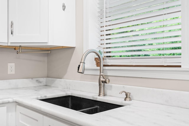 2849 Walnut Hill Rd, Lexington, KY 40515 - kitchen view of a sink, white cabinetry, and light stone countertops