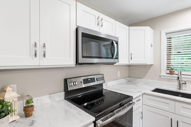2849 Walnut Hill Rd, Lexington, KY 40515 - kitchen with stainless steel appliances, a sink, and white cabinets