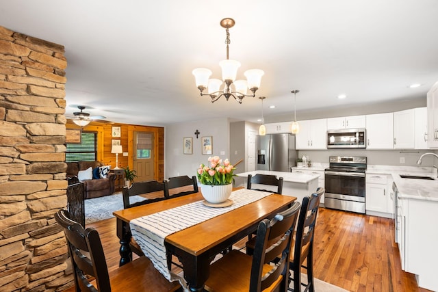 2849 Walnut Hill Rd, Lexington, KY 40515 - dining room with light wood finished floors, a ceiling fan, a chandelier, and recessed lighting