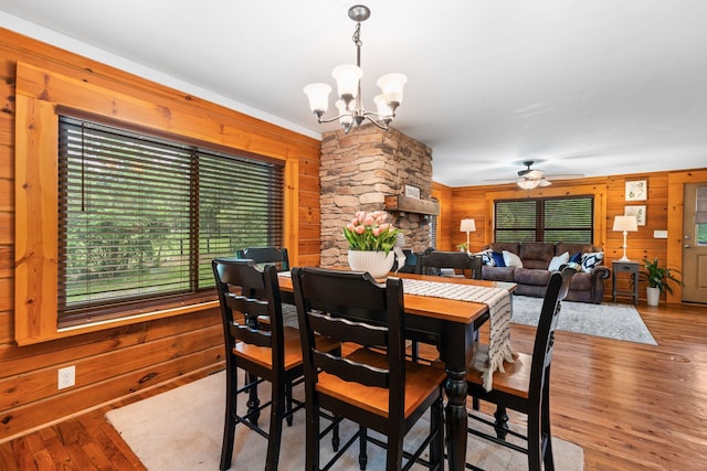 2849 Walnut Hill Rd, Lexington, KY 40515 - dining area with wood walls, a chandelier, a ceiling fan, and wood finished floors