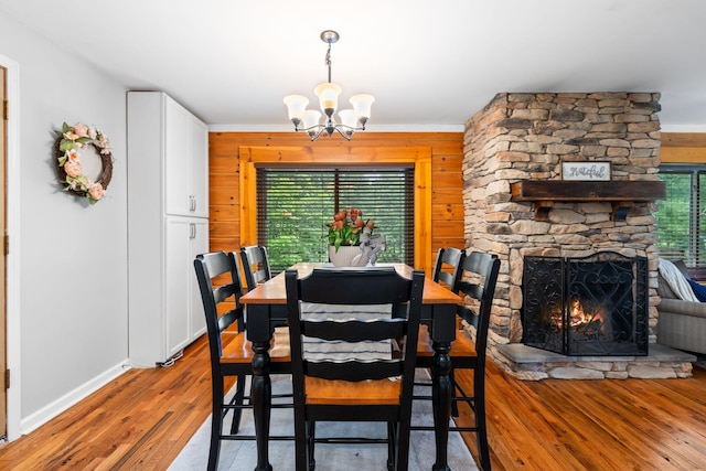 2849 Walnut Hill Rd, Lexington, KY 40515 - dining area with plenty of natural light, a chandelier, wood finished floors, wood walls, and baseboards