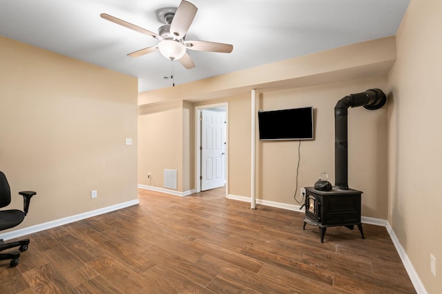2849 Walnut Hill Rd, Lexington, KY 40515 - office with a ceiling fan, wood finished floors, a wood stove, and baseboards