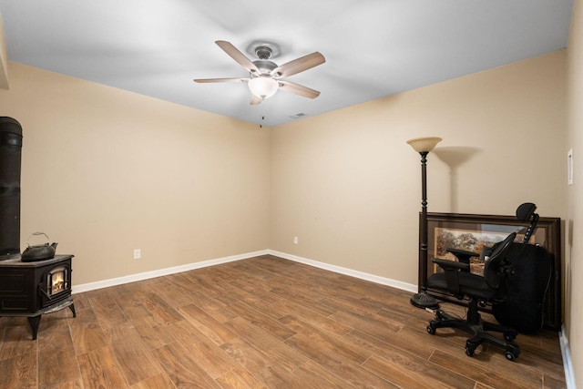 2849 Walnut Hill Rd, Lexington, KY 40515 - office area with a wood stove, a ceiling fan, wood finished floors, and baseboards