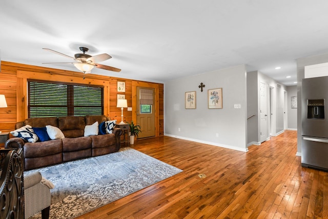 2849 Walnut Hill Rd, Lexington, KY 40515 - living area featuring a ceiling fan, wooden walls, hardwood / wood-style floors, baseboards, and plenty of natural light