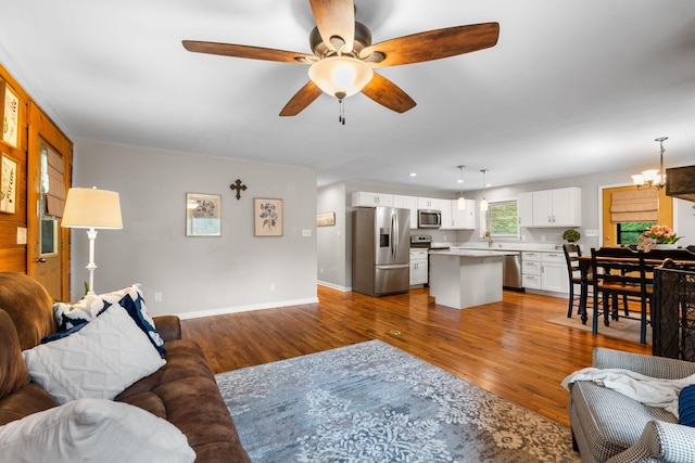 2849 Walnut Hill Rd, Lexington, KY 40515 - living area featuring wood finished floors, a ceiling fan, baseboards, and a chandelier