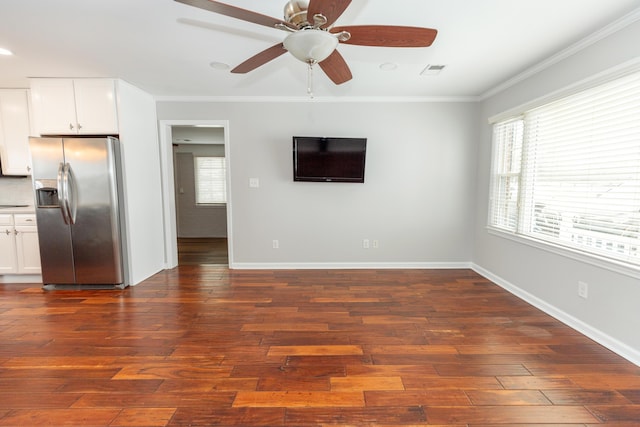 9412 Harrodsburg Rd, Wilmore, KY 40390 - unfurnished living room with crown molding, healthy amount of natural light, a ceiling fan, dark wood-style flooring, and baseboards