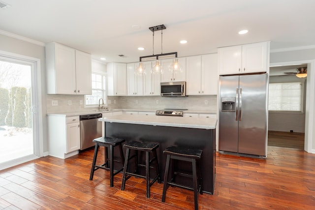 9412 Harrodsburg Rd, Wilmore, KY 40390 - kitchen with appliances with stainless steel finishes, crown molding, a sink, dark wood-type flooring, and white cabinetry