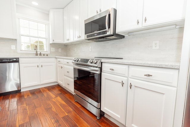 9412 Harrodsburg Rd, Wilmore, KY 40390 - kitchen with appliances with stainless steel finishes, a sink, backsplash, ornamental molding, and white cabinets