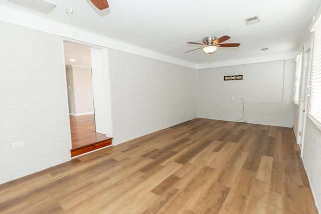 9412 Harrodsburg Rd, Wilmore, KY 40390 - empty room featuring a ceiling fan, wood finished floors, and brick wall