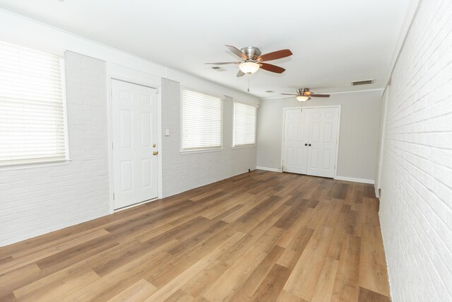 9412 Harrodsburg Rd, Wilmore, KY 40390 - entrance foyer featuring ceiling fan, brick wall, and wood finished floors