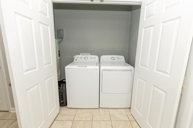 9412 Harrodsburg Rd, Wilmore, KY 40390 - washroom featuring washer and dryer, light tile patterned floors, and water heater