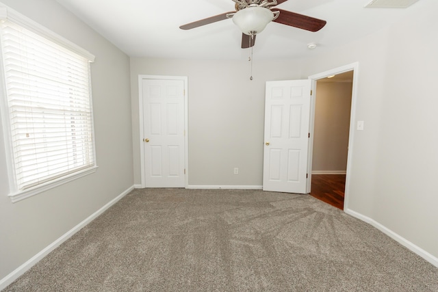 9412 Harrodsburg Rd, Wilmore, KY 40390 - unfurnished bedroom with carpet floors, multiple windows, and baseboards