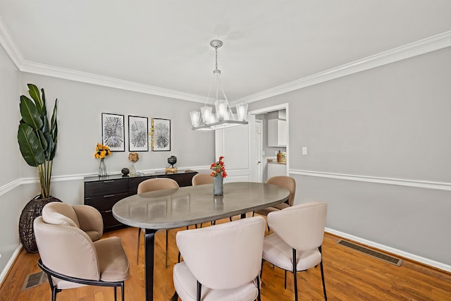 2152 Sallee Dr, Lexington, KY 40513 - dining room with baseboards, wood finished floors, ornamental molding, and a chandelier