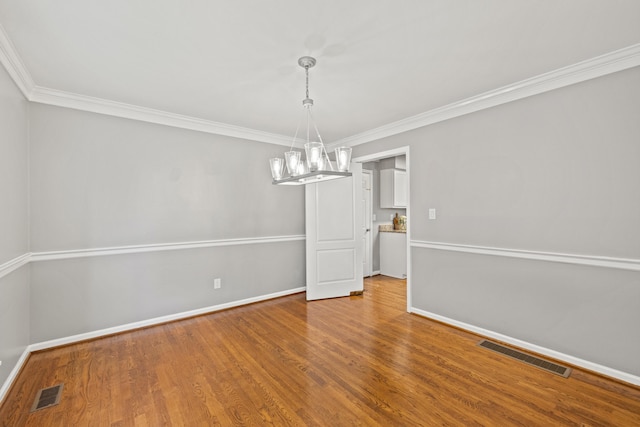 2152 Sallee Dr, Lexington, KY 40513 - empty room featuring a chandelier, baseboards, wood finished floors, and ornamental molding
