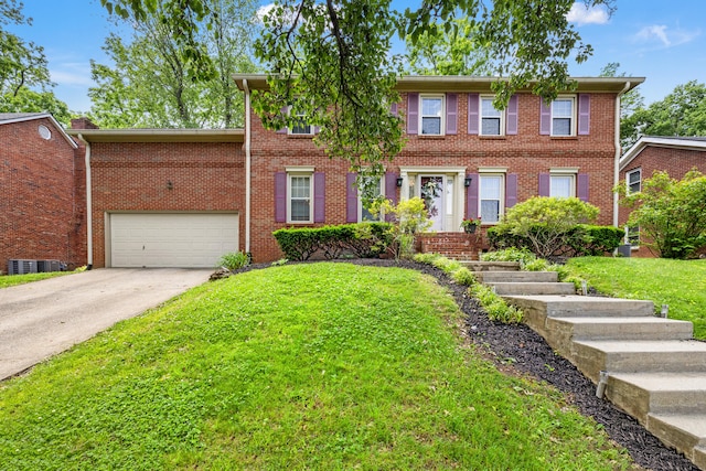2152 Sallee Dr, Lexington, KY 40513 - colonial-style house with a front yard, concrete driveway, and brick siding