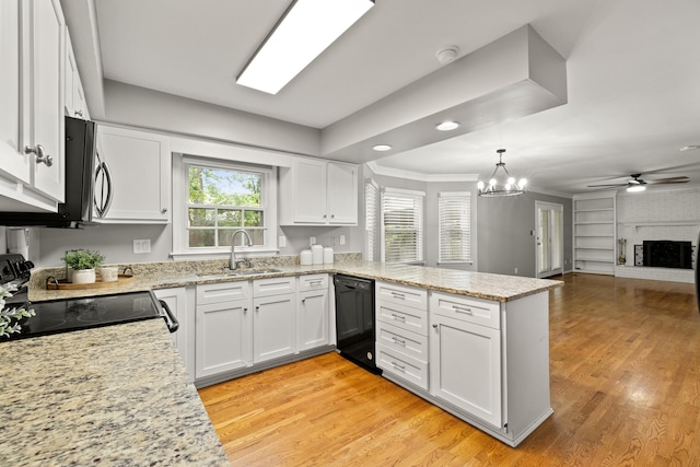 2152 Sallee Dr, Lexington, KY 40513 - kitchen featuring a sink, black appliances, a peninsula, white cabinets, and light wood-style floors