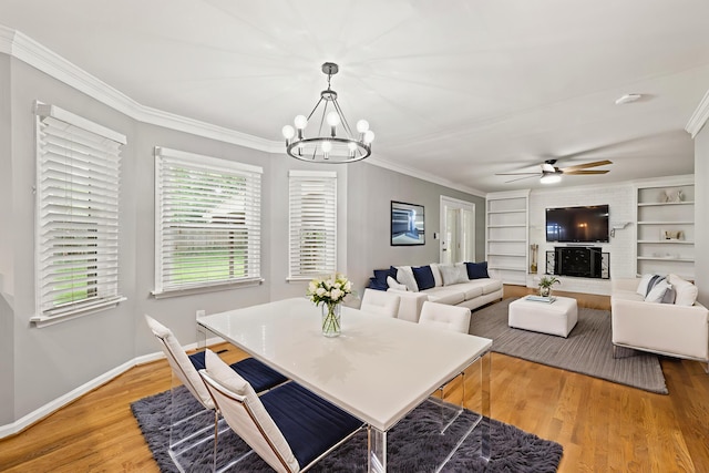2152 Sallee Dr, Lexington, KY 40513 - dining room featuring a chandelier, ornamental molding, a ceiling fan, light wood-style flooring, and baseboards