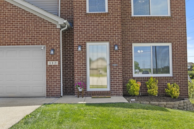112 Covington Way, Richmond, KY 40475 - view of exterior entry with brick siding, driveway, a lawn, and an attached garage