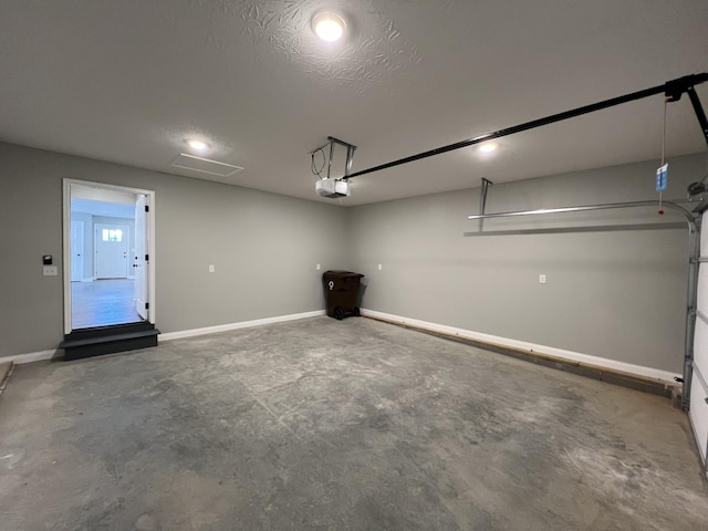309 Gallahadion Ct, Winchester, KY 40391 - garage featuring a garage door opener and baseboards