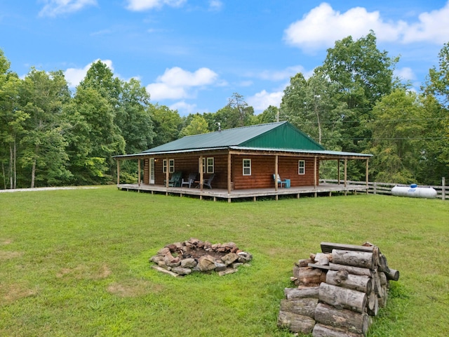 225 Grover Back Rd, Rogers, KY 41365 - back of house with an outdoor fire pit, metal roof, a wooden deck, and a forest view