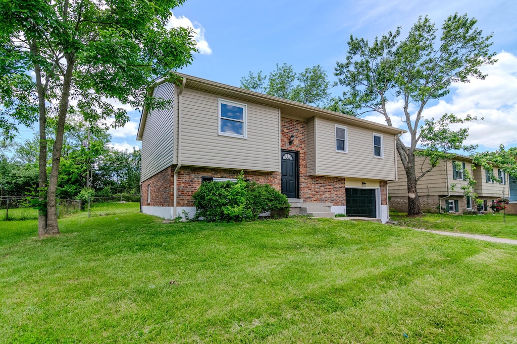 3617 Sundart Dr, Lexington, KY 40517 - bi-level home with brick siding, a garage, and driveway