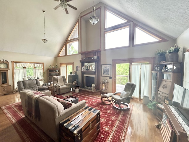12430 E Ky-10, Quincy, KY 41166 - living area with high vaulted ceiling, a ceiling fan, hardwood / wood-style flooring, plenty of natural light, and a textured ceiling
