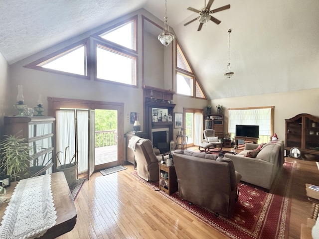 12430 E Ky-10, Quincy, KY 41166 - living area with high vaulted ceiling, a fireplace, ceiling fan, and wood-type flooring