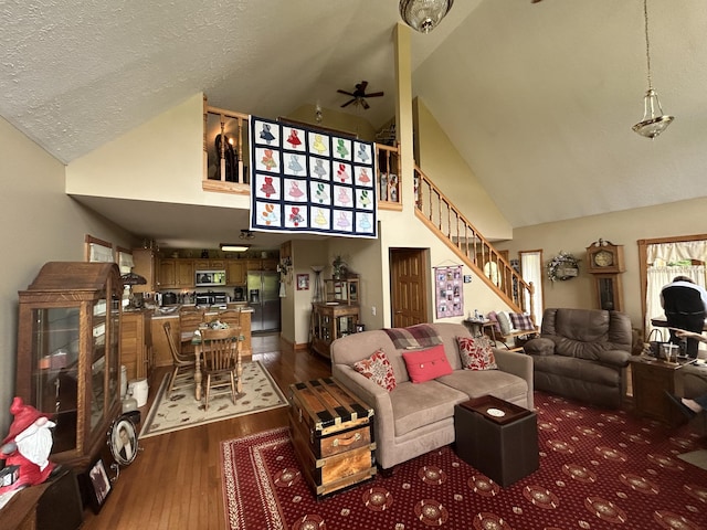 12430 E Ky-10, Quincy, KY 41166 - living room with a ceiling fan, high vaulted ceiling, stairs, hardwood / wood-style floors, and a textured ceiling