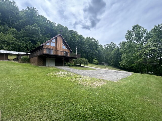 12430 E Ky-10, Quincy, KY 41166 - view of side of home featuring asphalt driveway, a wooden deck, a lawn, and a view of trees