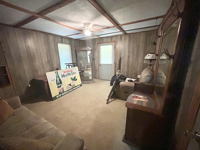12430 E Ky-10, Quincy, KY 41166 - living area featuring wood walls, a ceiling fan, carpet floors, and beam ceiling