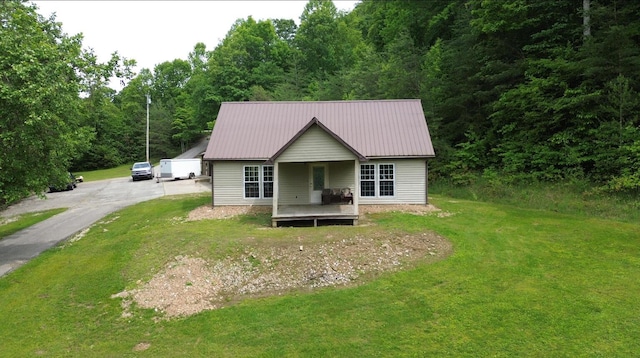 12430 E Ky-10, Quincy, KY 41166 - view of front of home with a front yard, driveway, metal roof, and a view of trees