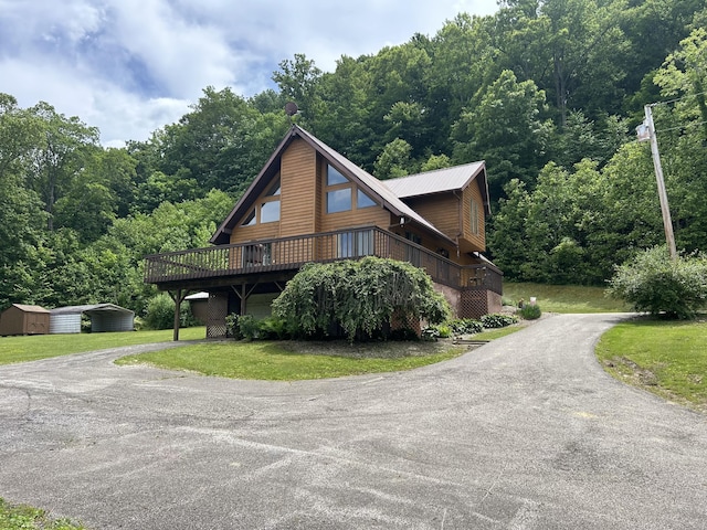 12430 E Ky-10, Quincy, KY 41166 - view of side of home featuring driveway, a lawn, a deck, and a view of trees