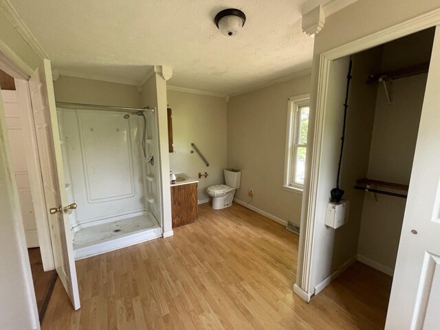 5069 Ky 11, Cannon, KY 40923 - bathroom with a shower stall, wood finished floors, a textured ceiling, ornamental molding, and vanity