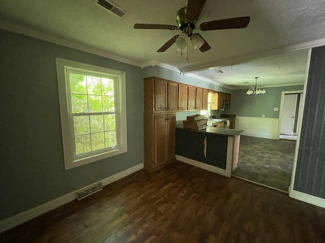 5069 Ky 11, Cannon, KY 40923 - kitchen featuring ornamental molding, a chandelier, a ceiling fan, brown cabinets, and dark wood-style floors