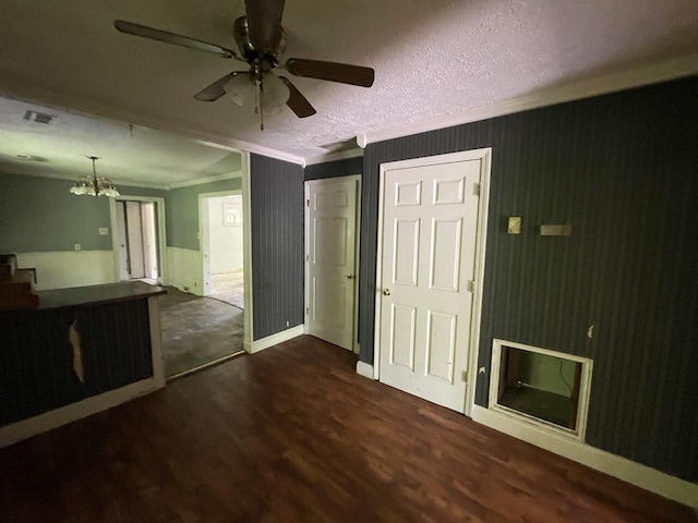 5069 Ky 11, Cannon, KY 40923 - unfurnished living room featuring dark wood-style floors, ceiling fan, a chandelier, crown molding, and baseboards