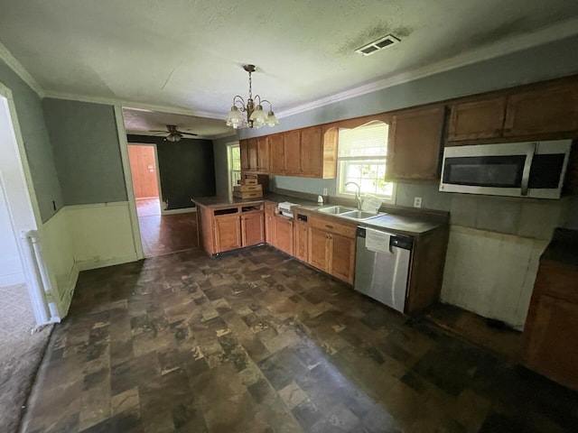 5069 Ky 11, Cannon, KY 40923 - kitchen with appliances with stainless steel finishes, a sink, crown molding, a chandelier, and a peninsula