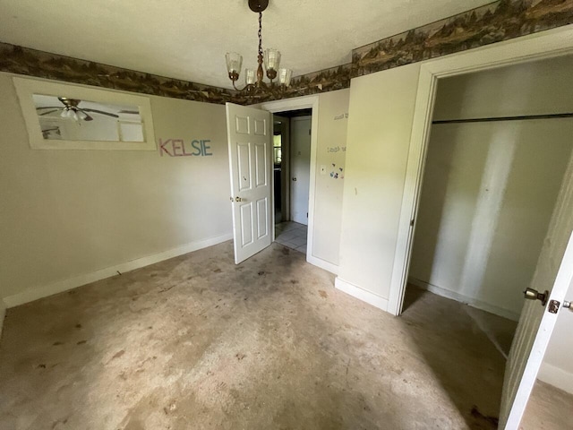 5069 Ky 11, Cannon, KY 40923 - unfurnished bedroom with unfinished concrete flooring, a chandelier, a closet, and baseboards