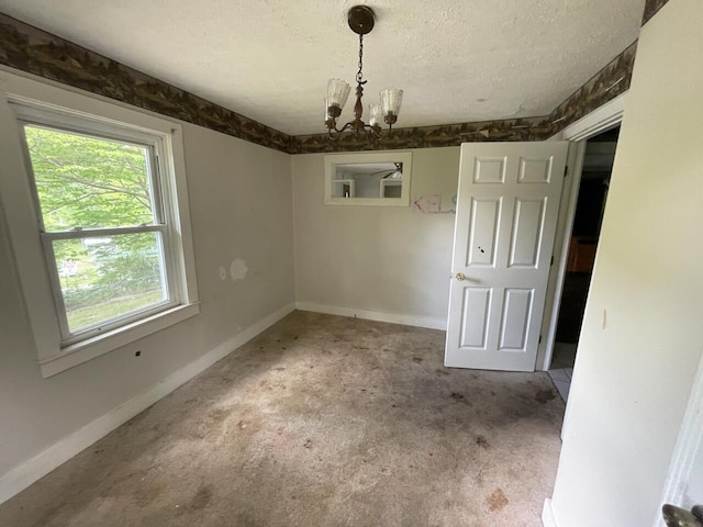 5069 Ky 11, Cannon, KY 40923 - unfurnished dining area with a chandelier, a textured ceiling, baseboards, and carpet flooring