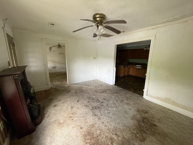 5069 Ky 11, Cannon, KY 40923 - carpeted empty room with a wood stove, a ceiling fan, and baseboards