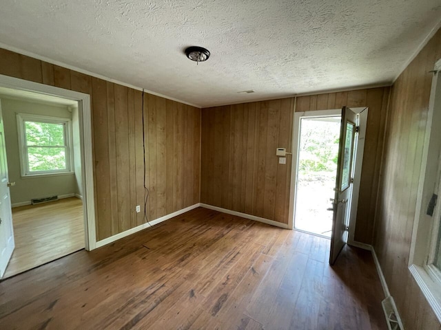 5069 Ky 11, Cannon, KY 40923 - entrance foyer featuring hardwood / wood-style floors, plenty of natural light, wooden walls, a textured ceiling, and baseboards