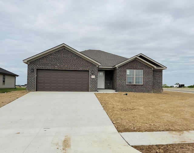 473 Wyldwood Way, Berea, KY 40403 - ranch-style house with brick siding, an attached garage, concrete driveway, and a shingled roof