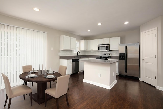 2429 Aristocracy Cir, Lexington, KY 40509 - kitchen with appliances with stainless steel finishes, dark wood-style flooring, tasteful backsplash, white cabinets, and recessed lighting
