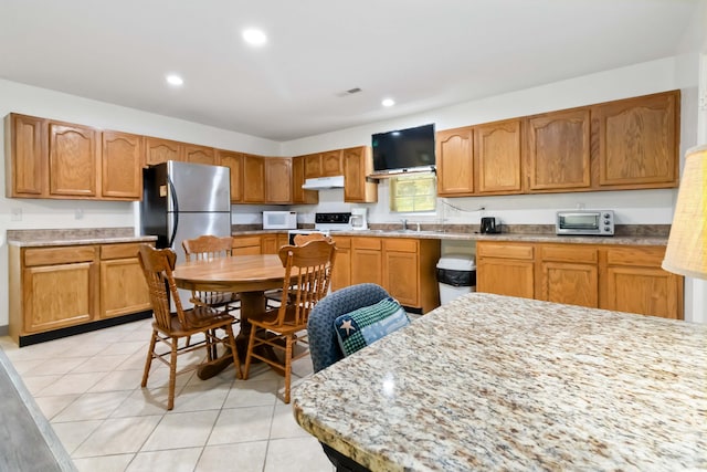 5830 Old Keno Rd, Burnside, KY 42519 - kitchen with under cabinet range hood, light tile patterned floors, light countertops, recessed lighting, and white range
