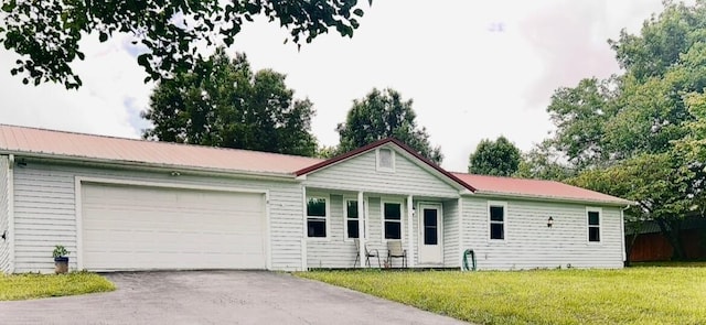 127 Circle St, London, KY 40744 - single story home featuring asphalt driveway, a front yard, a garage, and a metal roof