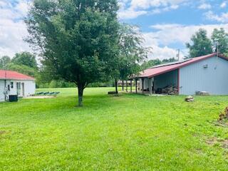 127 Circle St, London, KY 40744 - view of grassy yard with a pole building, a carport, and an outbuilding
