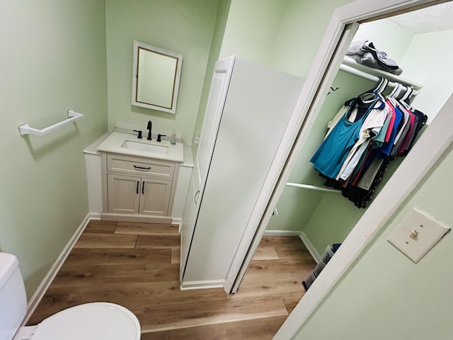 127 Circle St, London, KY 40744 - half bath featuring vanity, wood finished floors, and a walk in closet