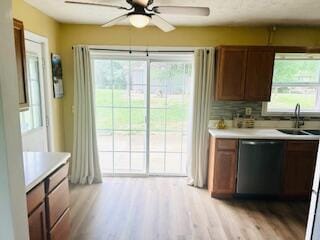 127 Circle St, London, KY 40744 - kitchen with stainless steel dishwasher, a sink, light wood-style floors, and light countertops
